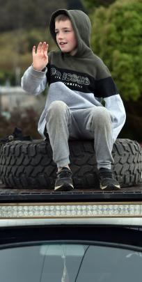 Lukas Kelley, of Dunedin, waves to passing trucks.