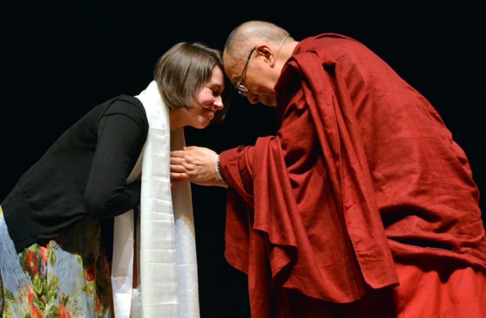 Dunedin City Councillor Jinty Mctavish farewells the Dalai Lama after his speech.