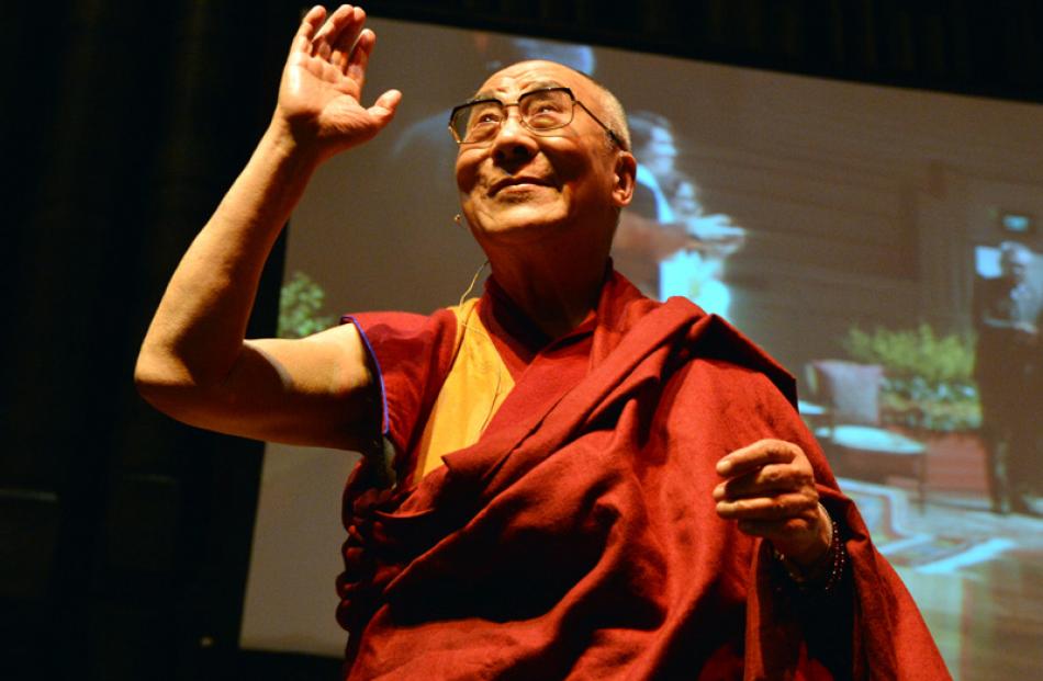 The Dalai Lama acknowledges a standing ovation.