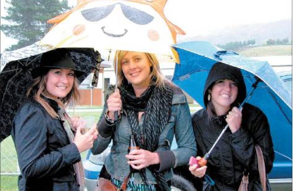 Sunny smiles: The rain did not dampen the good spirits of Queenstown residents (from left) Lucy...