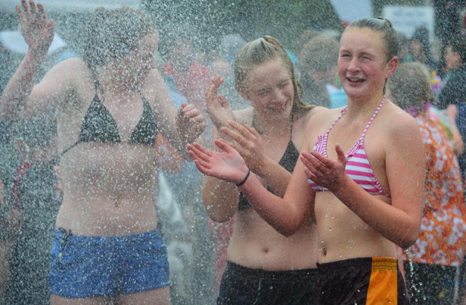 Revelling in the warm water from a fire truck are (from left) Tyla Clearwater (15),  Mackenzie...