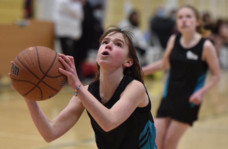Shelby Sutherland (12), from Big Rock School, looks for the hoop during a game against Bathgate...