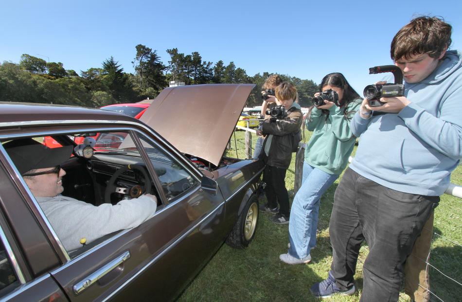 Smile please . . . Benjamin Snook of Rangiora poses with his Ford Escort Mk2 1600 as members of...