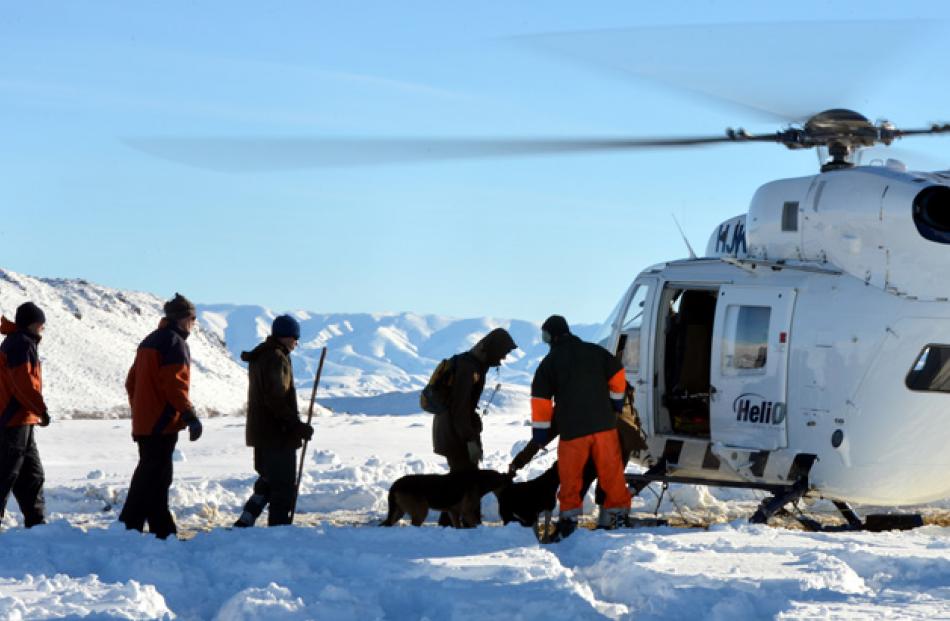 Rabobank staff (left) line up with shepherds to be flown into the lower Kakanui Range for snow...