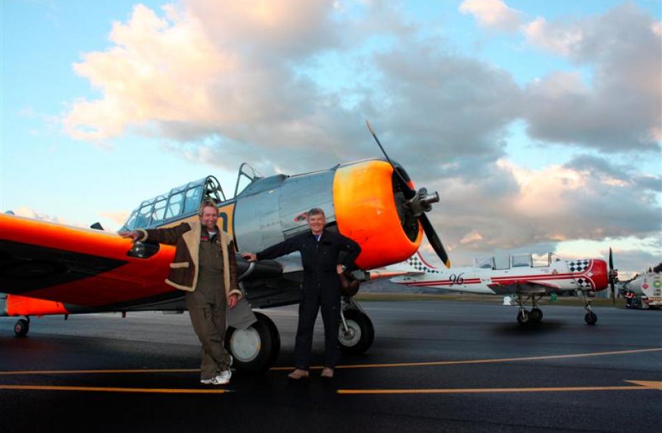 Pilots Peter Meadows (left) and John Lamont, both of Wanaka, stand in front of a Harvard T6 at...