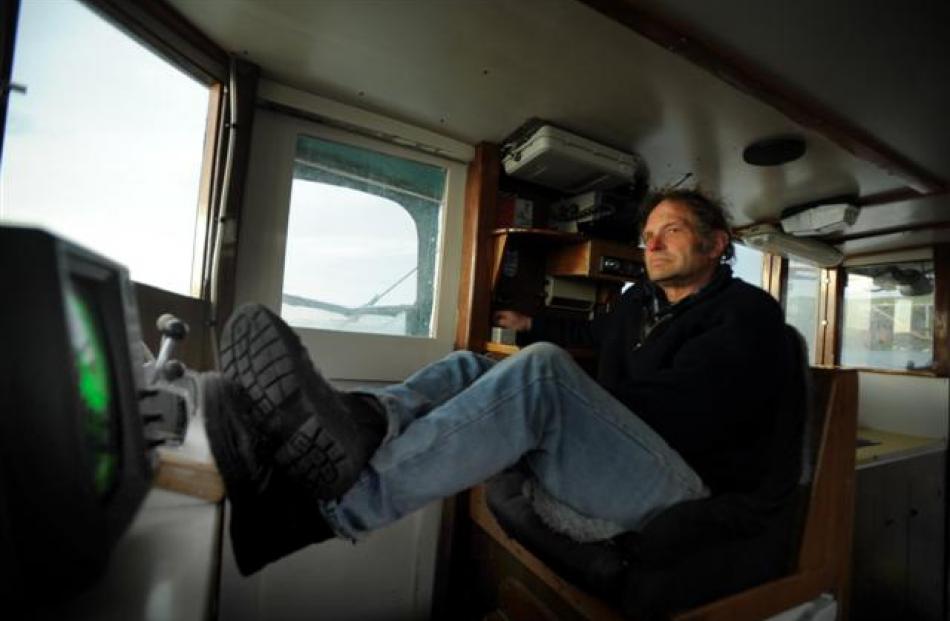 With the course set for home, Arty relaxes at the wheel. During their typical four-month fishing...