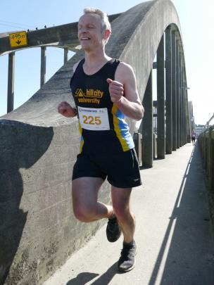 Mark Geddes, of Dunedin, crosses the Balclutha Bridge during his 10km Cross Recreation Centre run...