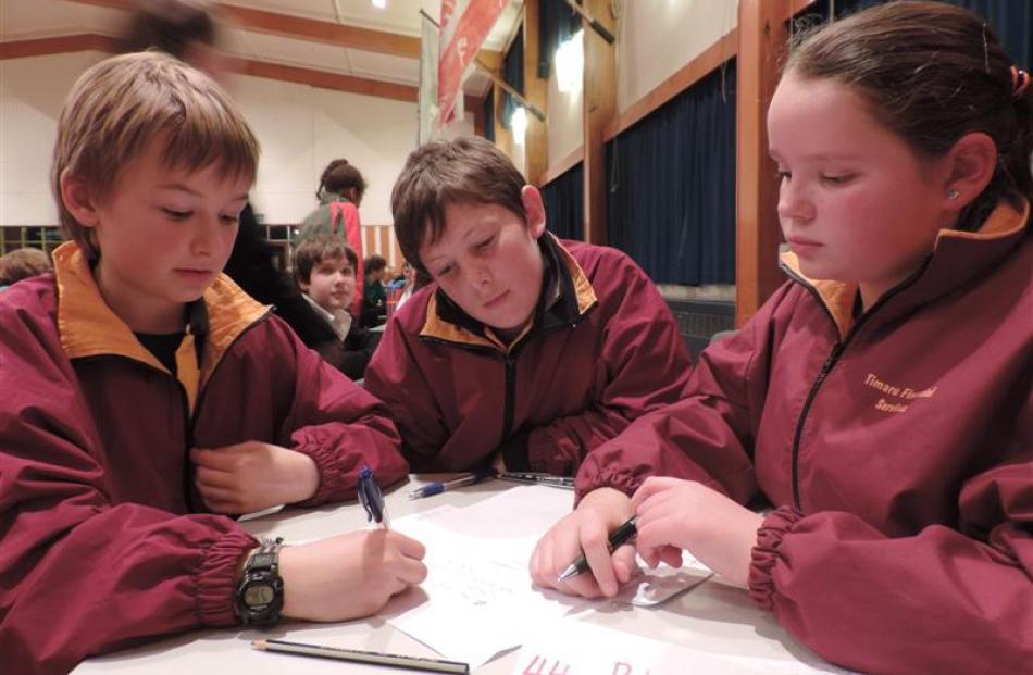 Mulling over a tough question last night are the Bluestone School 3, Timaru, team of (from left)...