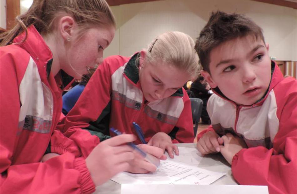 Hard at work and checking out the opposition last night are the Barton Rural School, Timaru, team...