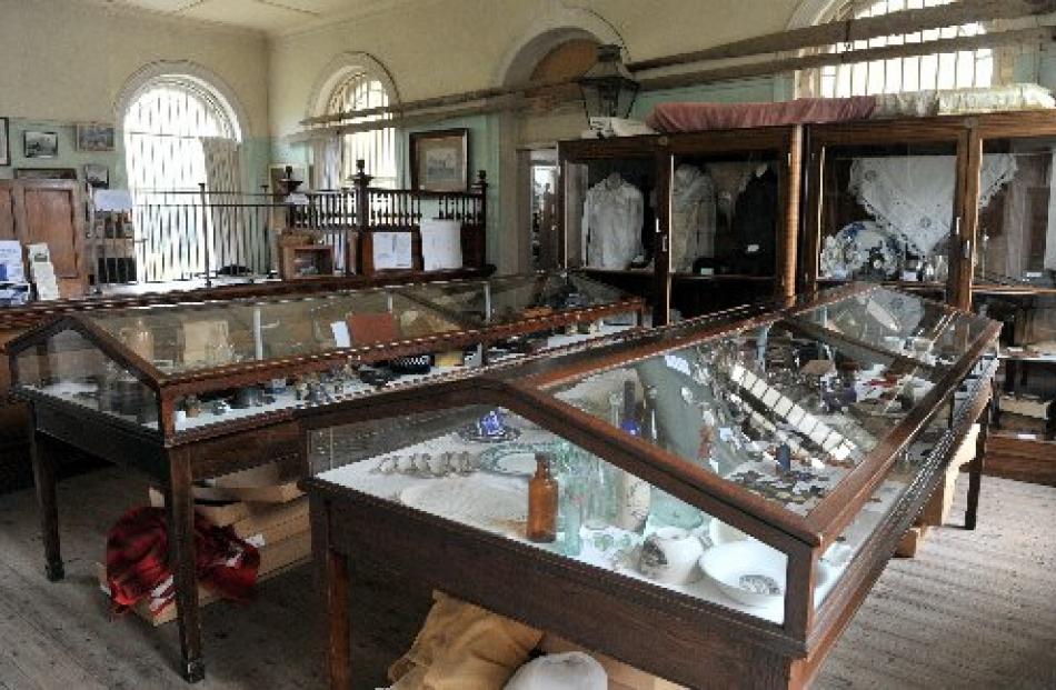 In the former banking chamber, oars from a whaleboat are mounted on the wall and display cases...