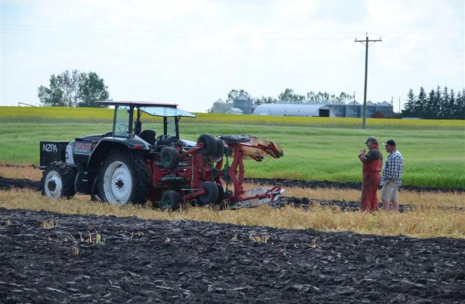 Discussing conditions during the practice session for the World Ploughing Championships in...