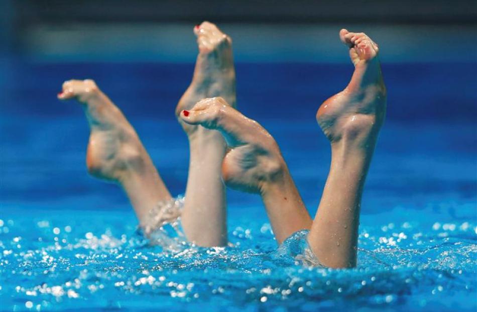 Russia's Svetlana Kolesnichenko and Svetlana Romashina perform in the synchronised swimming duet...