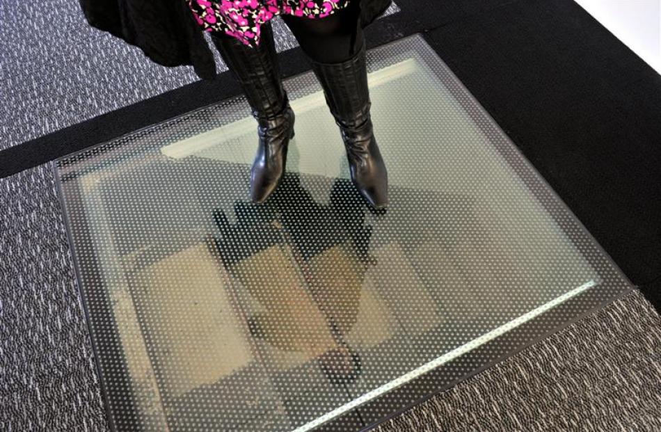 A strengthened glass floor panel at the Perpetual Trust Lounge reveals part of the original...