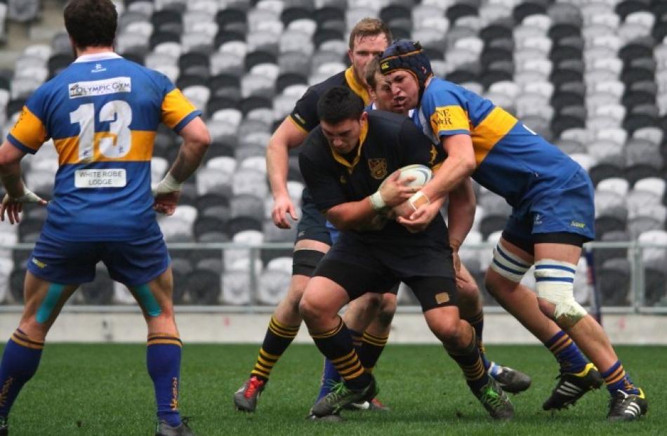 Dunedin captain Sam Anderson-Heather fights his way through several Taieri tacklers.