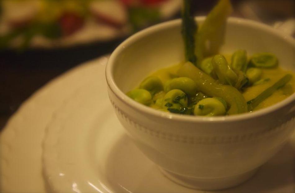 A dish of dried fava-bean puree topped with fresh favas and chicory.
