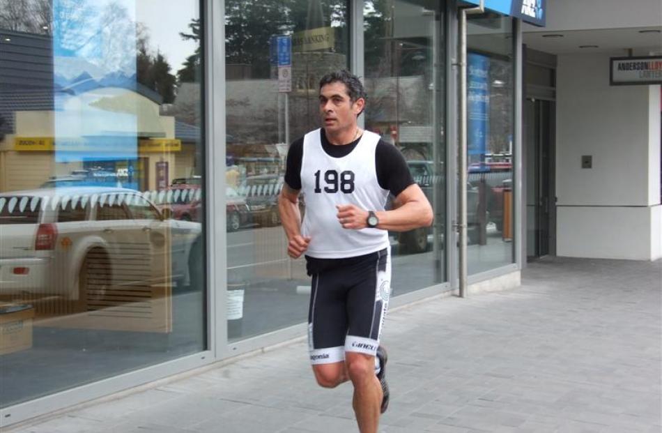 Nathan Favaae  runs through central Queenstown.
