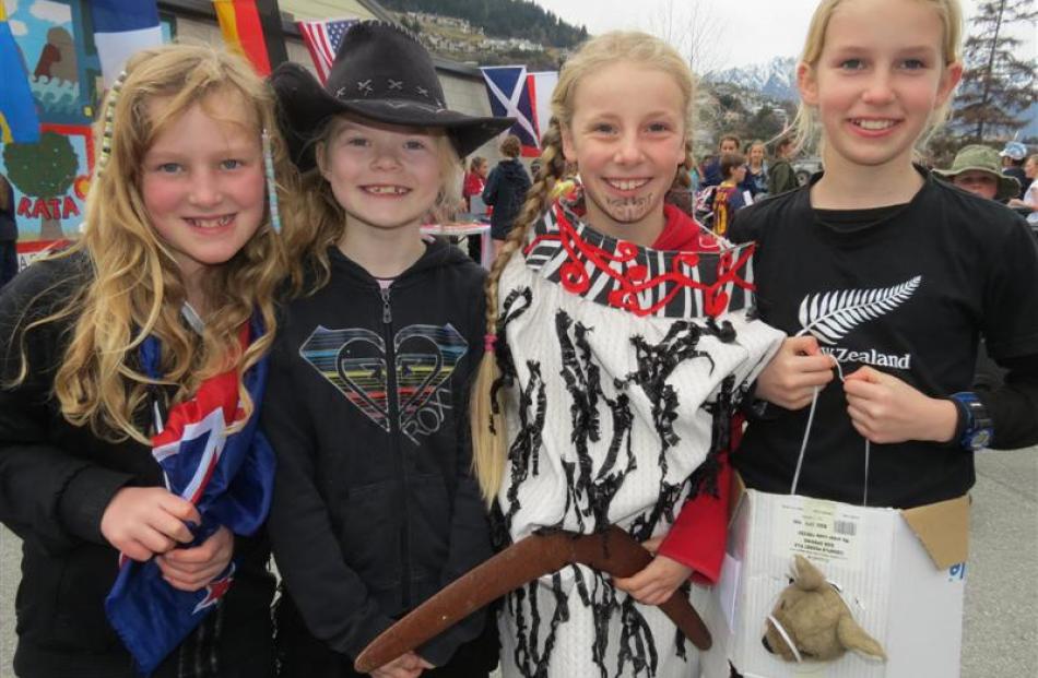 Pupils (from left) Abby Dunn (10), stands for New Zealand, alongside Texan representative Millie...