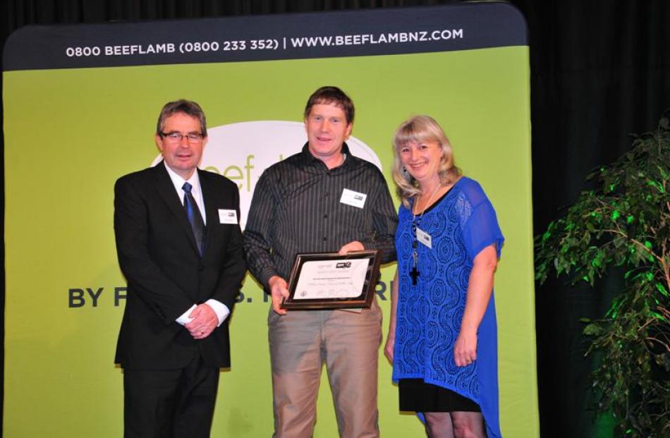 Richard Wakelin (left) from Beef and Lamb NZ congratulates Andrew and Heather Tripp, of Nithdale...