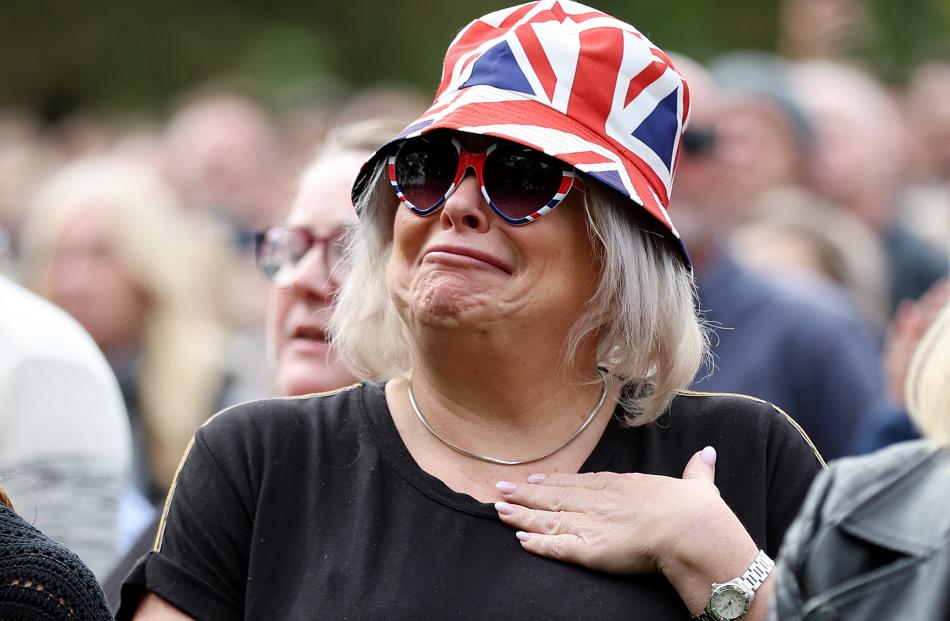 A member of the public reacts in Windsor, England. The committal service at St George’s Chapel,...