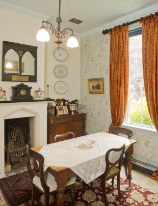 The dining room once had a chrome and tile fireplace and  nicotine-stained wallpaper. The new...