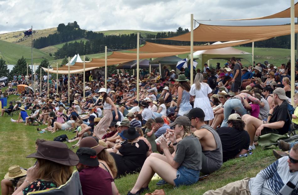 The large crowd watches the action from the grassy grandstand. PHOTO: GREGOR RICHARDSON