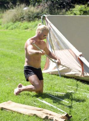 Tim Oats, of Dunedin, erects a tent during his family’s camping holiday at Bucklands Crossing...