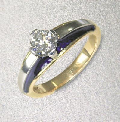 An 18ct gold and platinum diamond ring with blue enamel by Tony Williams.