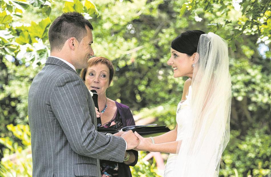 Sam and Jo Sharp with celebrant Lynn Greer at their wedding ceremony at Grandview Gardens in...