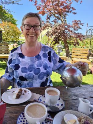 Joy Davis, of Mosgiel, has a cuppa and cake at Waitati yesterday. Photo: Lois Davis