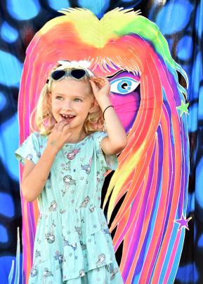 Freyja Fitzmaurice (6), of Dunedin, poses with a psychedelic glow-in-the-dark wall hanging at the...