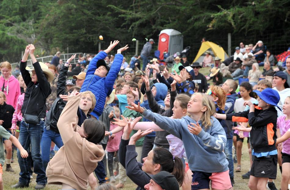 Children flock for a lolly scramble.