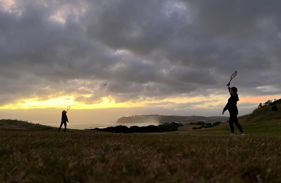 Sisters Annabel (16) and Isla (13) Ludgate playing in the twilight at Chisholm Park Golf Course,...