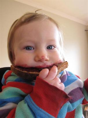 Ezra Heath enjoys a slice of his parent's sourdough bread.