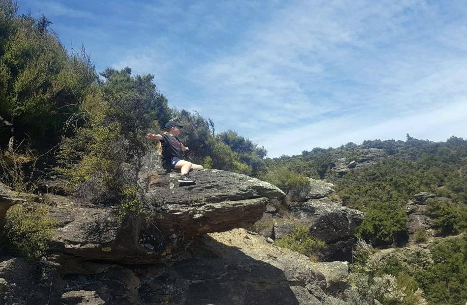 Jorja Robertson (12), of Fairfield, flies on a dragon-shaped rock on the Aurora Track, Bendigo,...