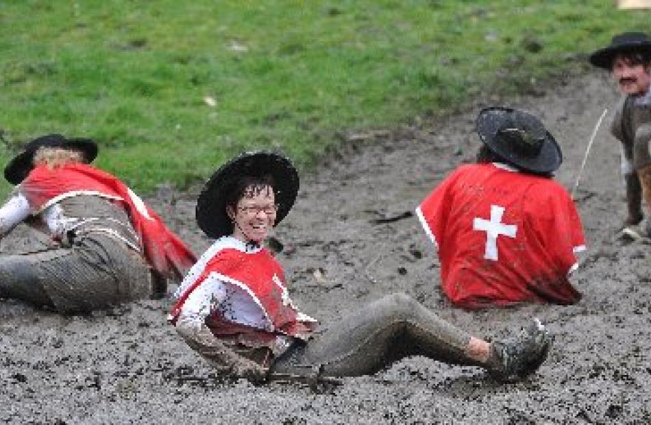 Musketeer Jane Pearce enjoys her slide into the mud.