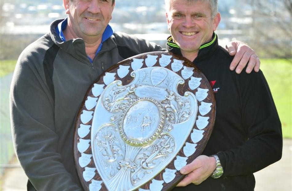 Former Otago players Richard Knight and David Latta  hold the shield.