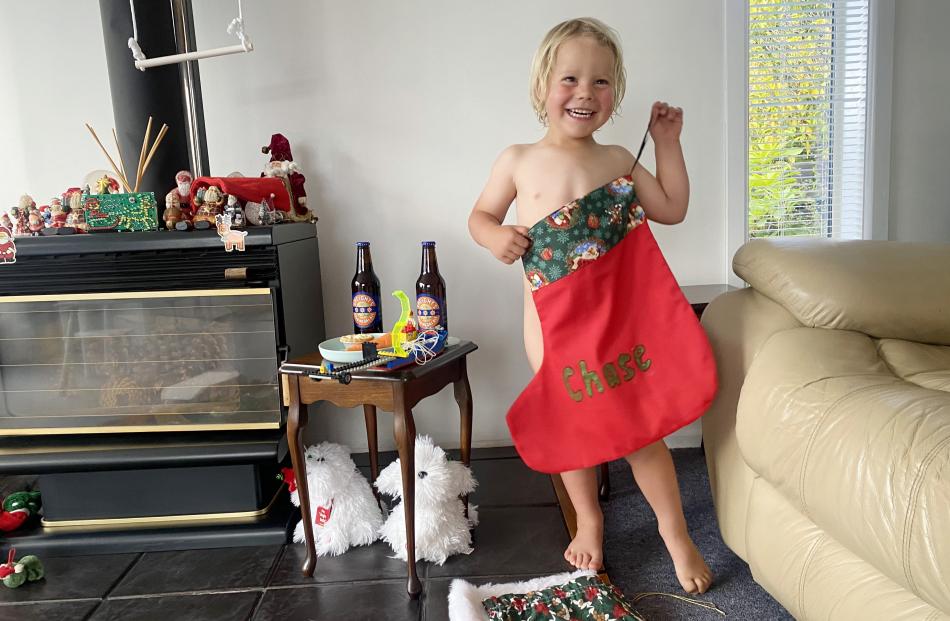 Chase Palmer (3), of Albert Town, opens his Christmas stocking at Nana’s house in Dunedin. PHOTO:...