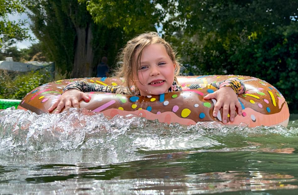 Blake Randell-Duncan (5) has fun in her floaty doughnut on a very hot day at Lake Aviemore. PHOTO...
