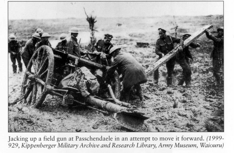 Soldiers jack-up a gun at Passchendaele in an attempt to get it moving. Photo by Army Museum,...