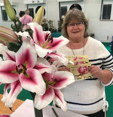 First-time exhibitor Sandra Wallis with her Oriental lily stem that scooped the pool at Saturday...