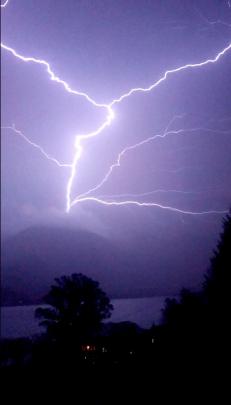 Rare upward lightning rises above Mount Roy, located by Wanaka's town centre. Photo by Max Stapper