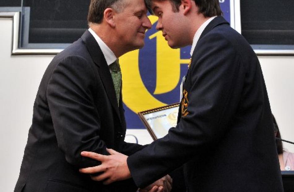 Tokomairiro High School pupil Tamahi Phillips gives a hongi to Prime Minister John Key.