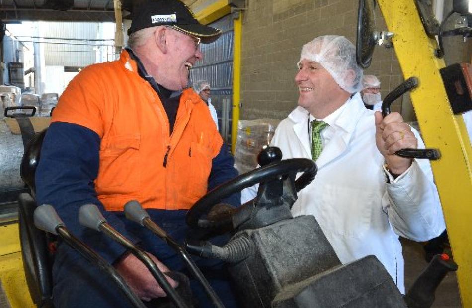 Harraways forklift driver Phil Cadman chats with Mr Key. Photos by Gerard O'Brien