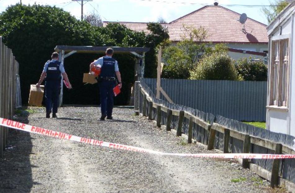 Police execute search warrants at a house on a back section in lower Exe St and at a Tees St...