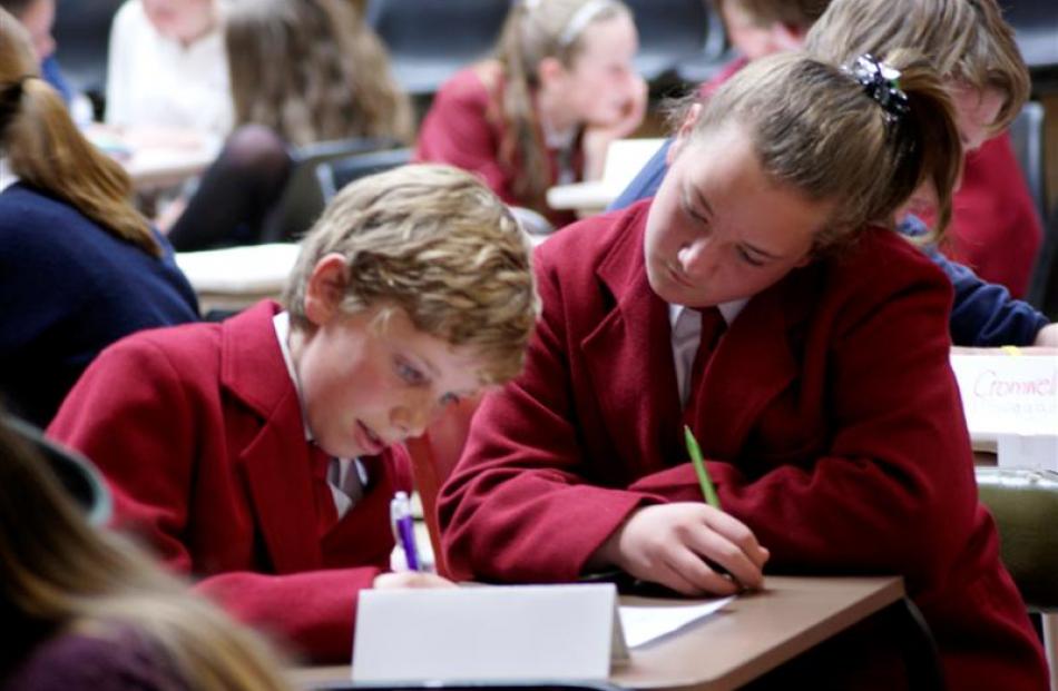 Sam O'Brien (13) and Polly Nyman (14), of  Dunstan High School get their answers down on paper.