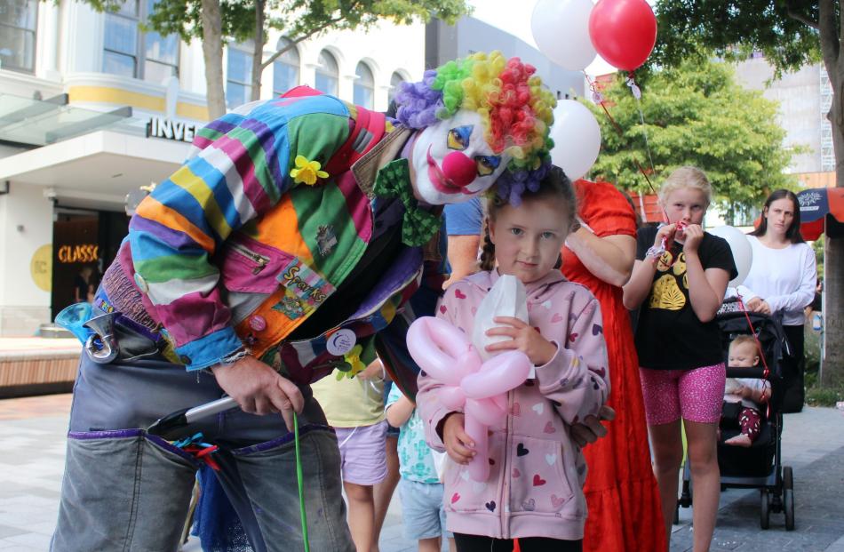 Clown Sparks makes a balloon animal for Dakota Fincher (7), of Invercargill.