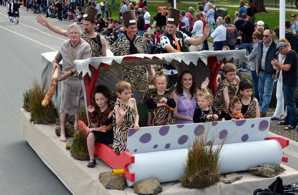 Festival princess Sarah Hesson rides along with the Flinstones float, made by Lodge Manuherikia.