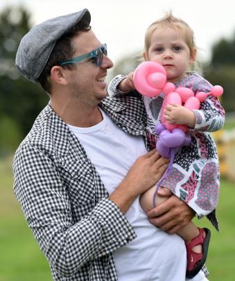 Eloise Cameron (1) strikes it lucky by spending the day with dad Mike, getting a balloon animal...