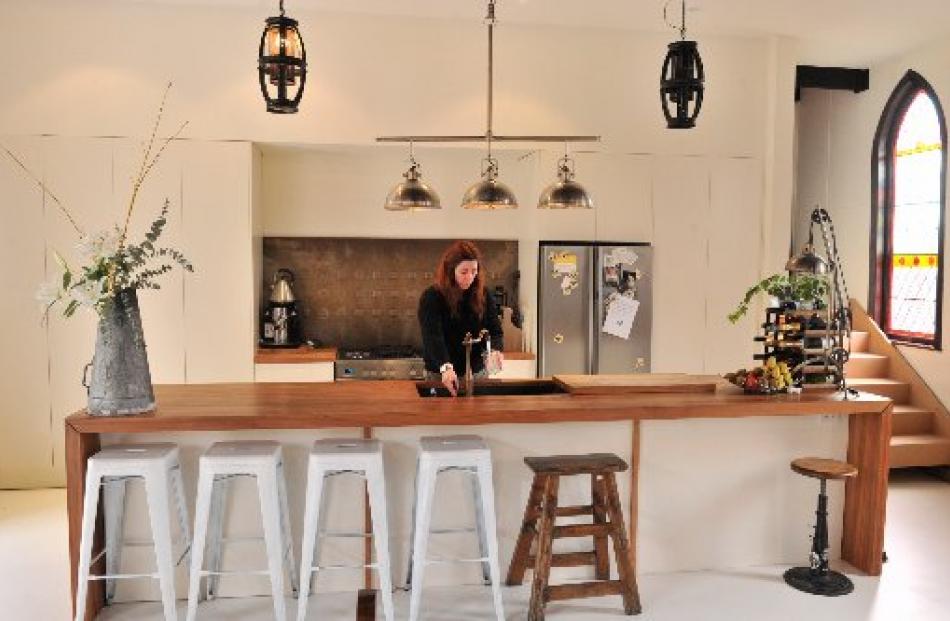 Jaimee Whiston in the kitchen. The stairs at right lead to the new mezzanine floor. Photo by...