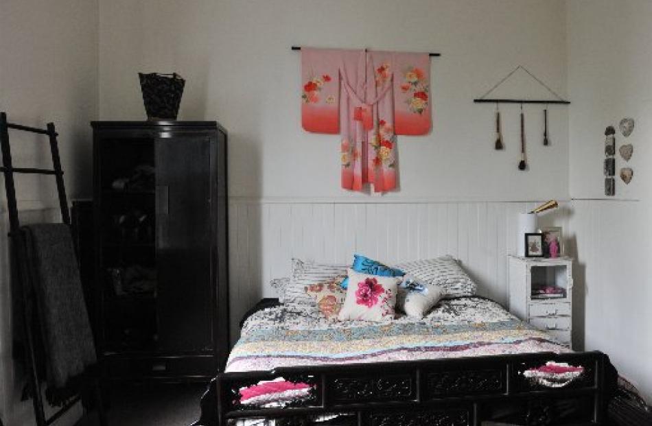 The main bedroom features oriental furniture and fabrics that Jaimee bought on a work-related...